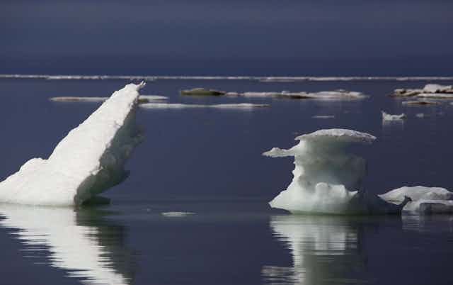 Ice floes jut at angles out of mostly empty seawater.