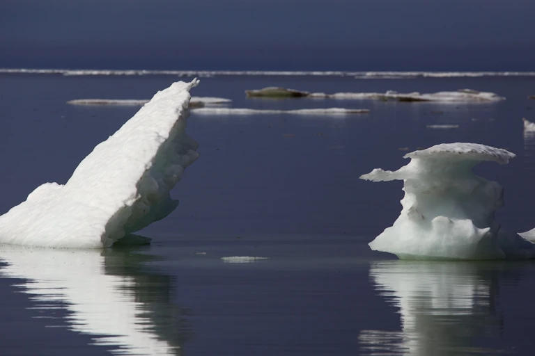 Ice floes jut at angles out of mostly empty seawater.