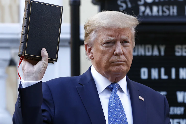 Donald Trump holds a bible up.