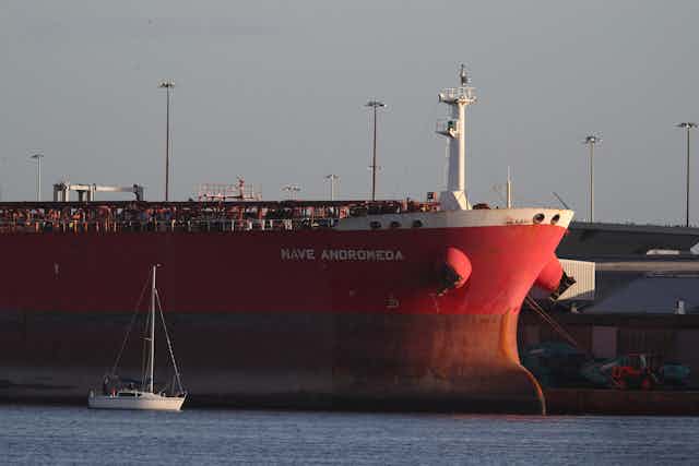 A docked red tanker ship.