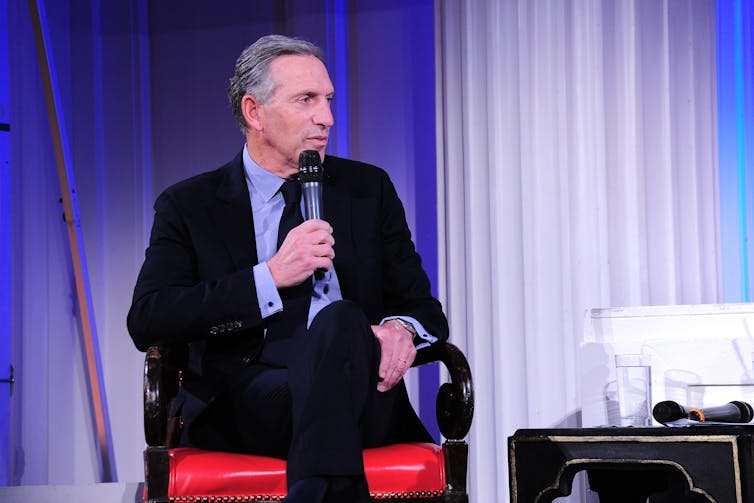 Howard Schultz speaks at a panel discussion.