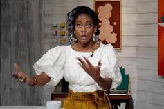 An African American female author speaks during a talk show.