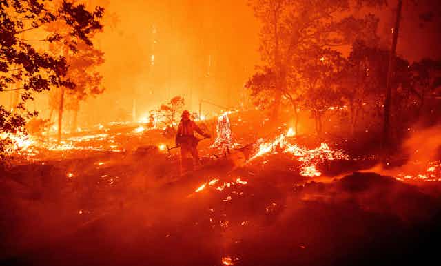 A firefighter fighting flames in California.