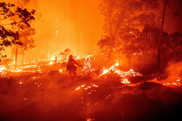 A firefighter fighting flames in California.