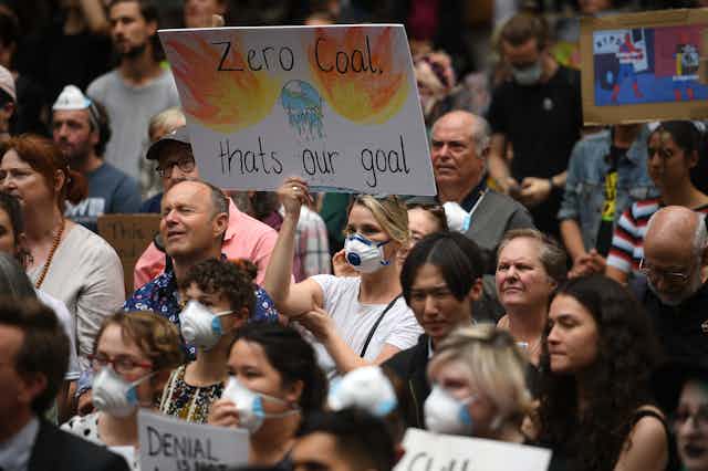 A protestor holds up a sign saying "zero coal that's our goal"