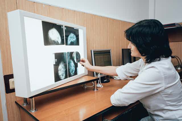 A doctor examining mammography test