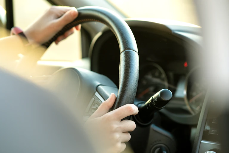Hands on steering wheel.
