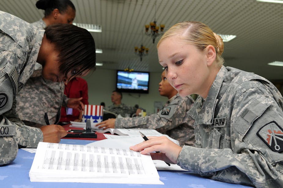 U.S. military members fill out their absentee ballots 