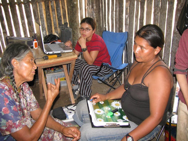 medical workers interview a Tsimane woman