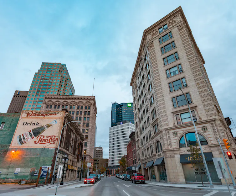 Photograph of downtown Winnipeg with a vintage advertisement on the side of a building.