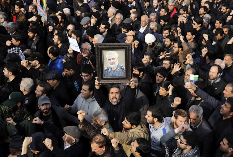 crowd with portrait of a man