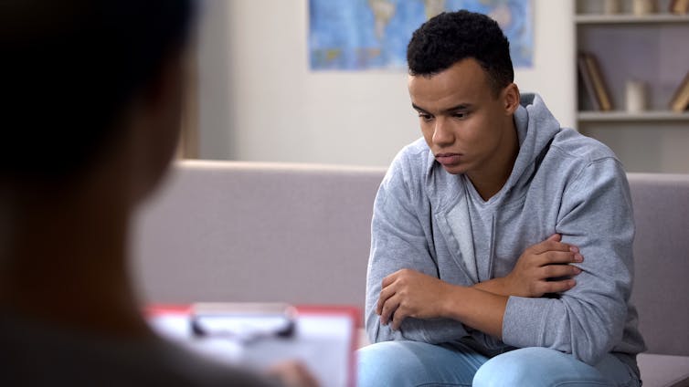 A young man talking to a psycologist.