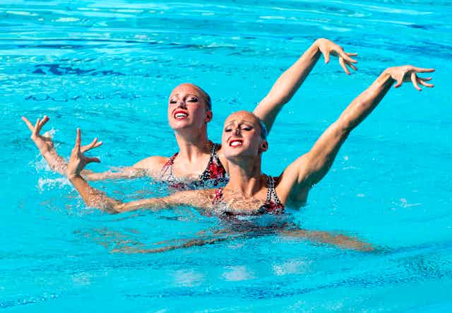 A photograph of two swimmers performing a synchronized routine 