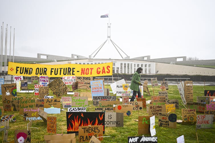 Protest signs outside Parliament House in Canberra