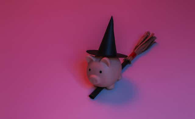 Piggy bank wearing a witches hat.