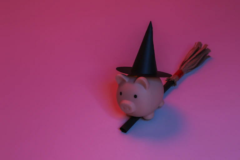 Piggy bank wearing a witches hat.