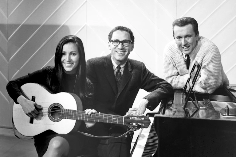 Singer Julie Felix, comedian Tom Lehrer and TV presenter David Frost in BBC's Shepherd's Bush studio in 1966.