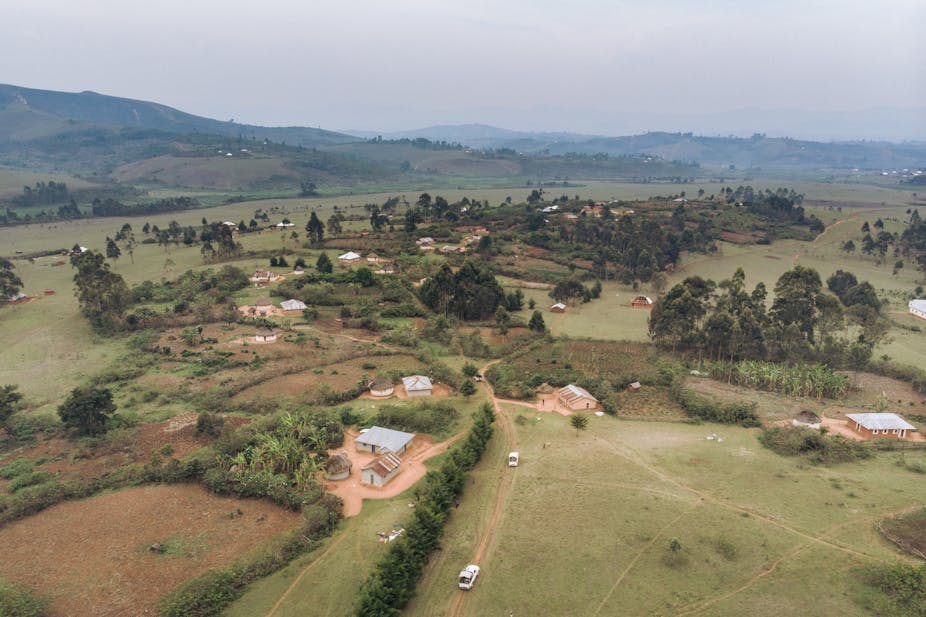Aerial view of a rural landscape with vehicles on the road