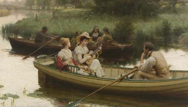 A woman serenades a female and male companion in a row boat.