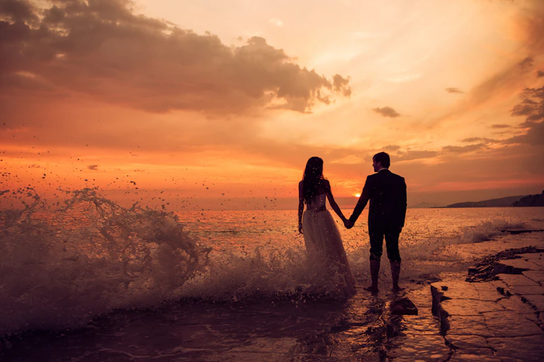 Picture of a newlywed couple on a beach.