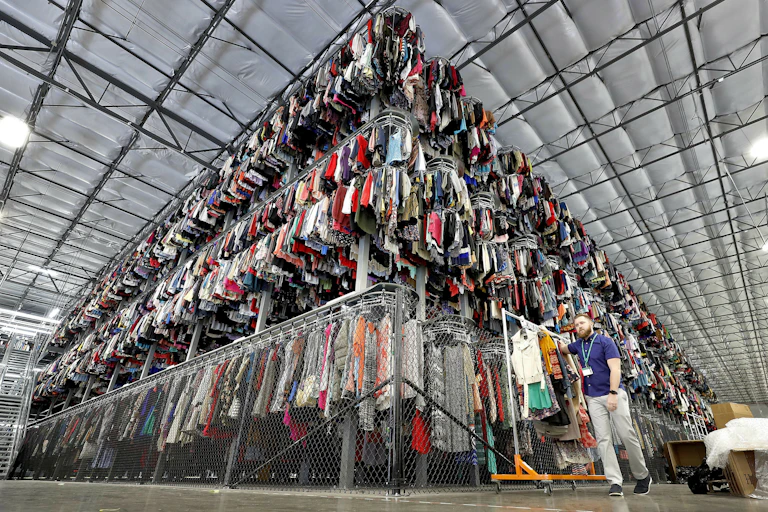 Thousands of garments are stored on a three-tiered conveyor system.