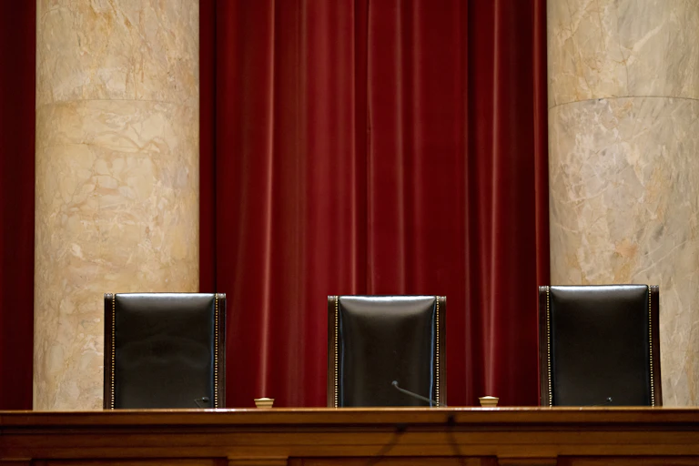Three judges' chairs in a courtroom