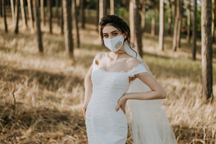 Bride wearing a white bridal face mask.
