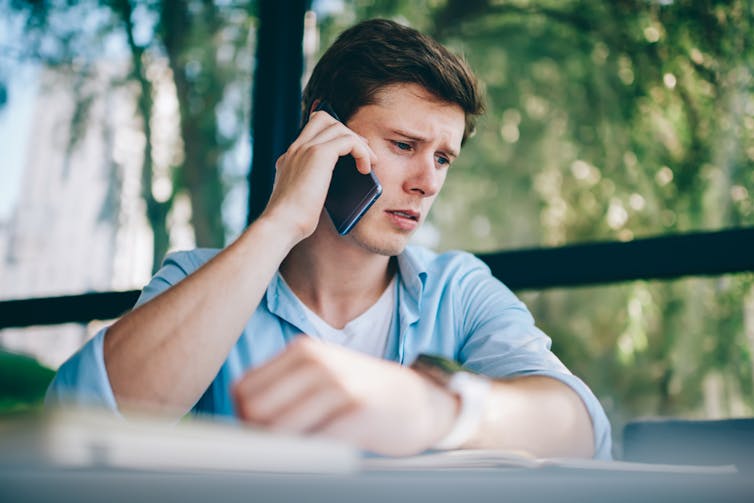 Young man speaking to someone on a smartphone