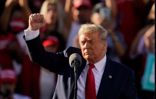Donald Trump pumps his fist at a rally.