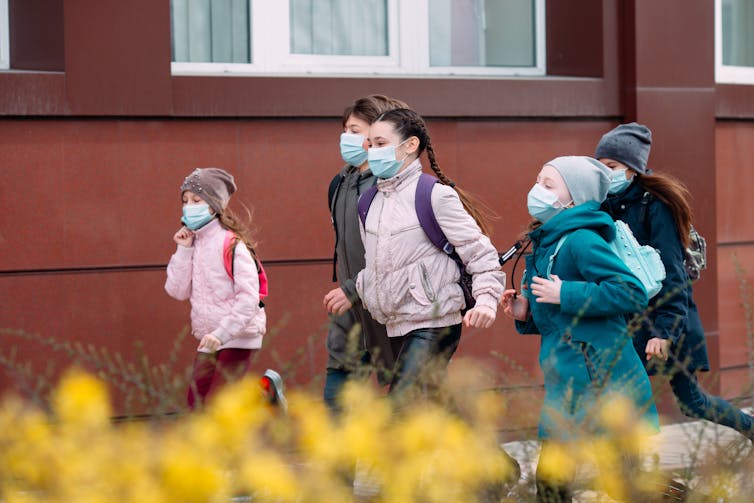 Children in masks leaving school