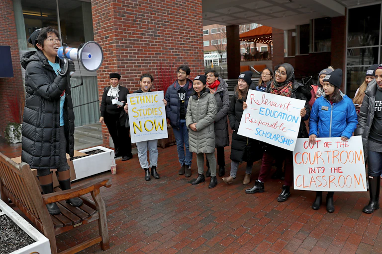 A group of college students hold a protest advocating for ethnic studies.