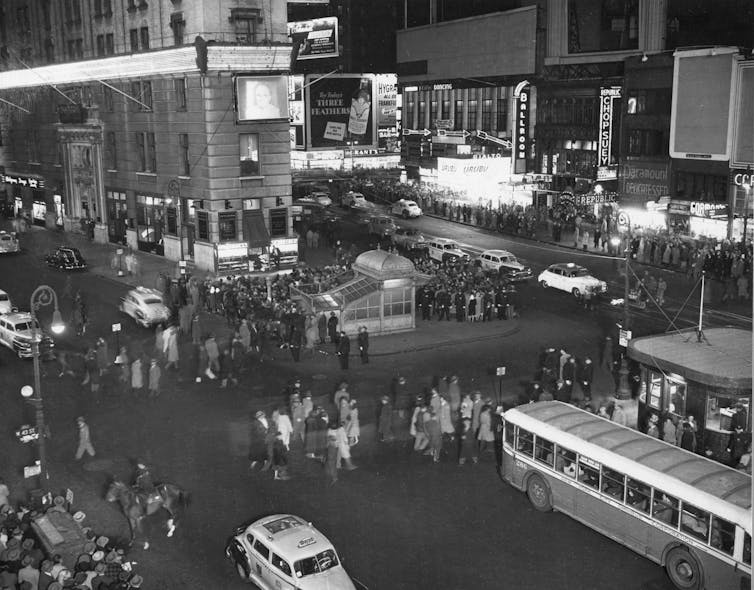 A sign and TV in Times Square on election night, 1948