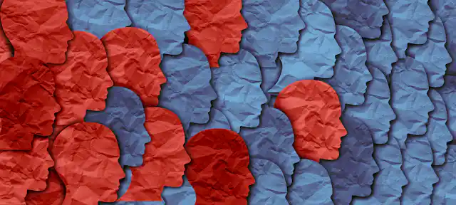Rostros de perfil, unos azules y otros rojos, hechos con papel.