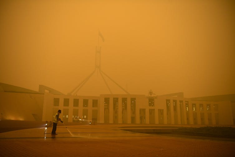 Orange smoke haze shrouds Parliament House.