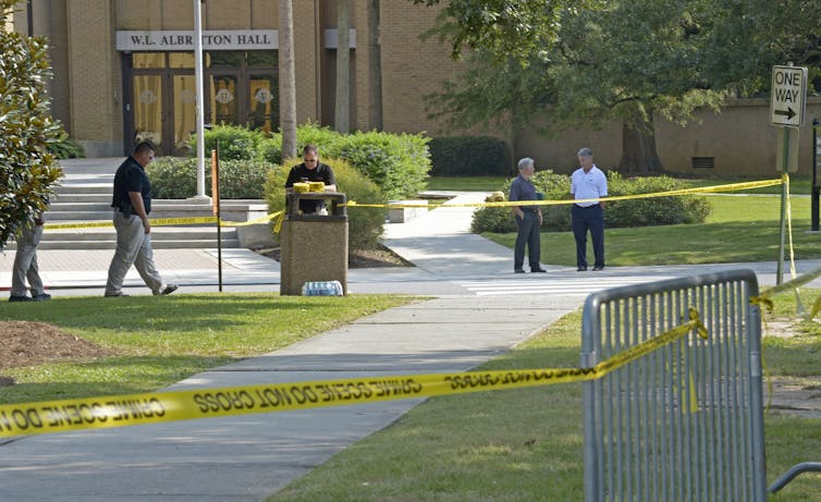Police tape around a university college building