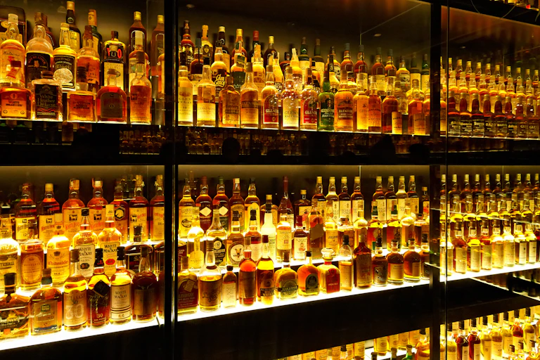 Rows of specialist whiskies on a gantry.