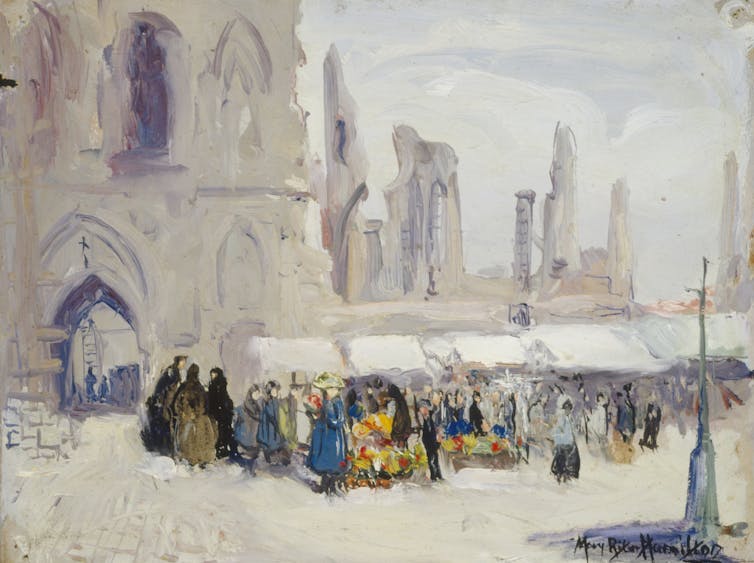 A market crowd in front of a church.
