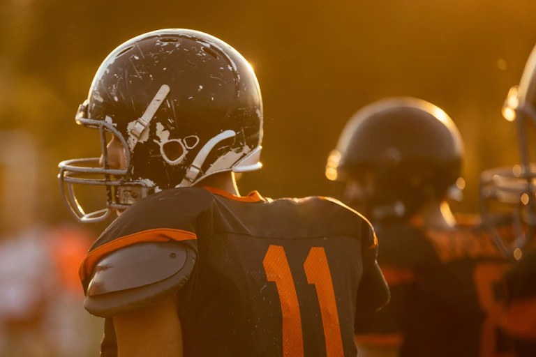 Football players on the sidelines.