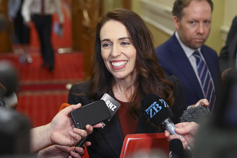 Jacinda Ardern with microphones