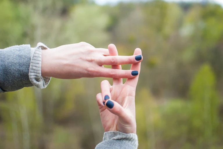 A women's hands making the symbol of a hashtag