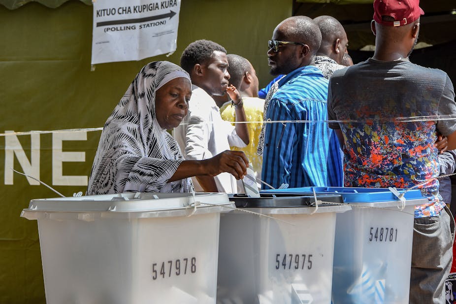 An elderly voter casts her ballot at Wazo Hill polling station in Dar es Salaam, Tanza