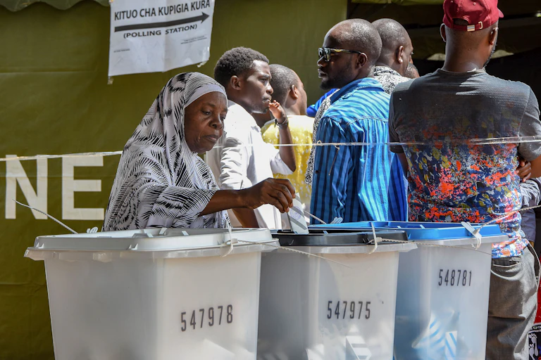 An elderly voter casts her ballot at Wazo Hill polling station in Dar es Salaam, Tanza