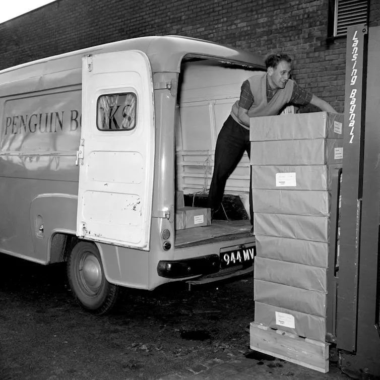 Men load a van with books, 1960.