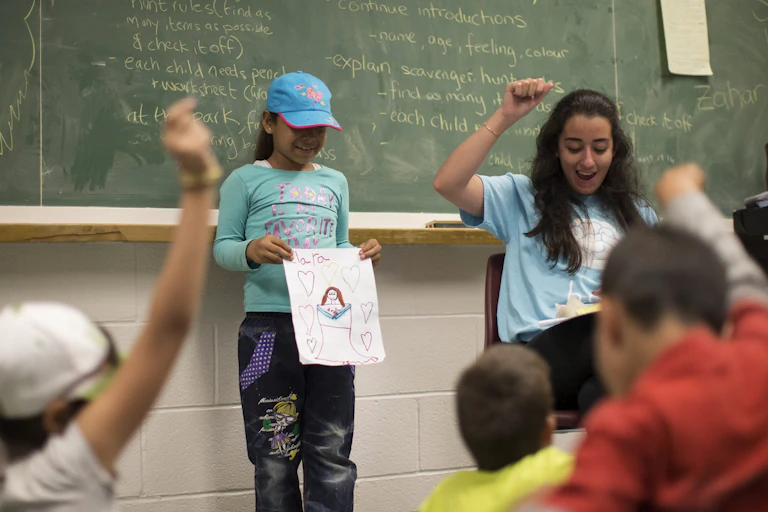 A child holds up a picture.