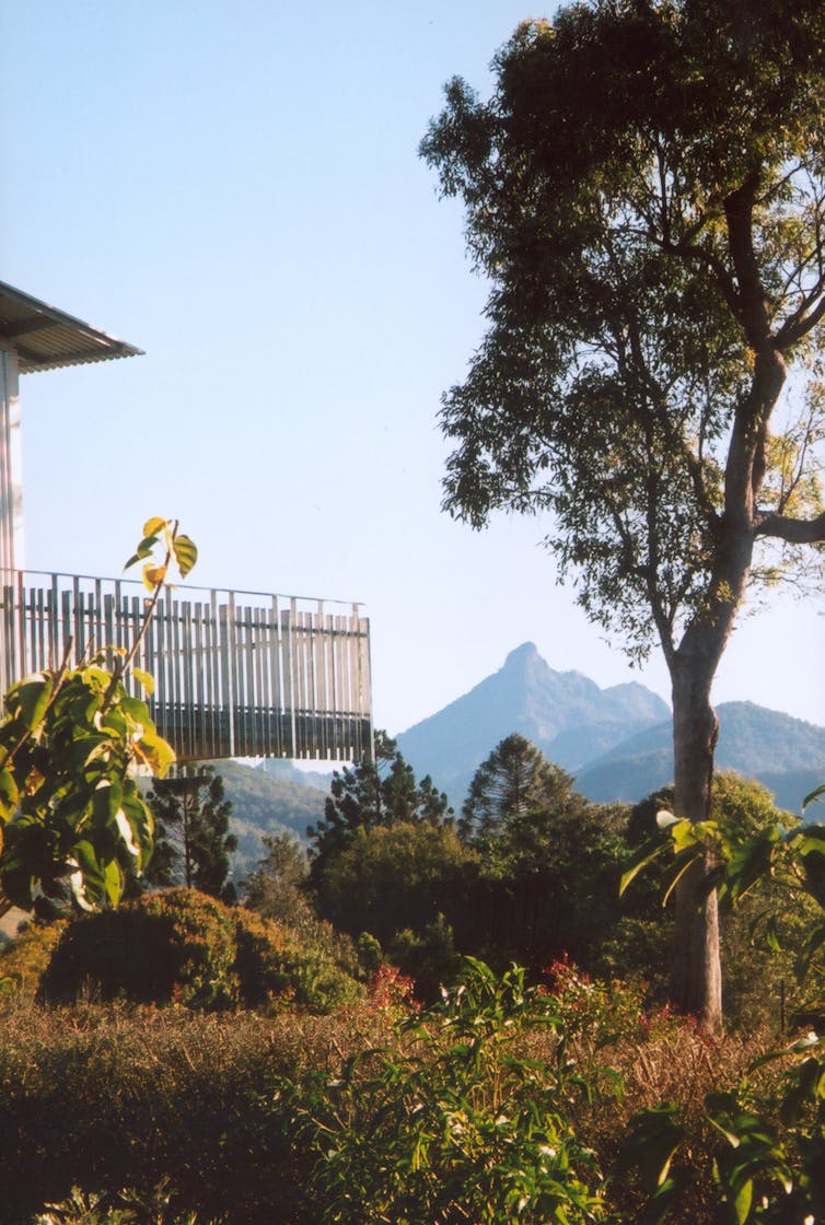 Decking around a gallery. A mountain rises in the background.