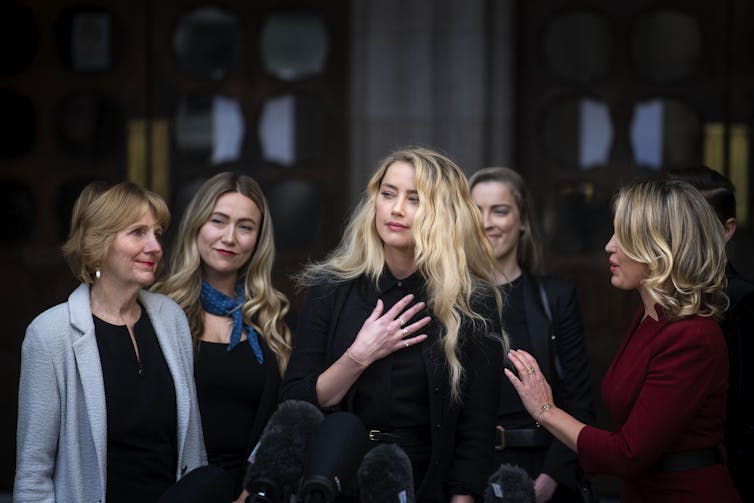 Actress Amber Heard with her sister and lawyer and supporters outside the UK High Court in London, July 2020.