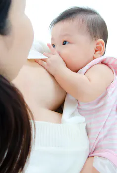 A mother breastfeeding her infant.