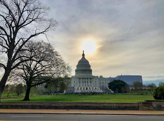 The sun sets over the U.S. Capitol Building.