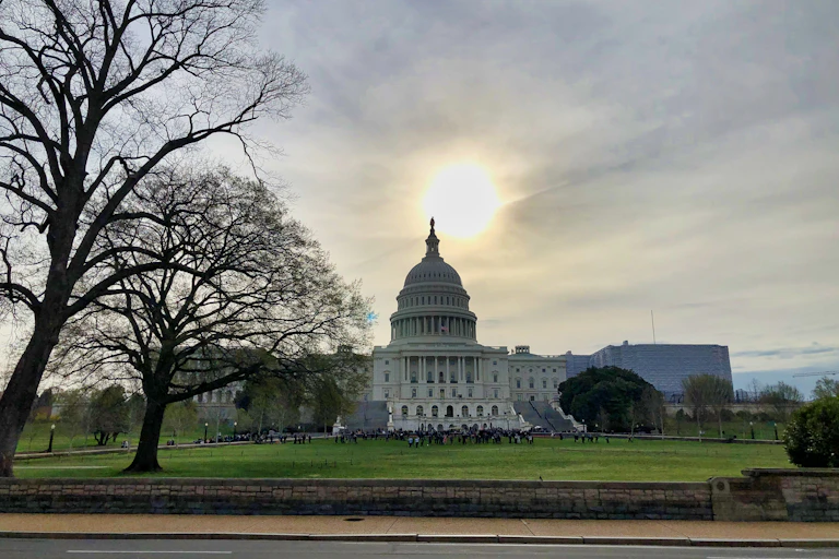 The sun sets over the U.S. Capitol Building.