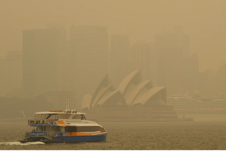 A ferry in Sydney Harbour blanketed in smoke.